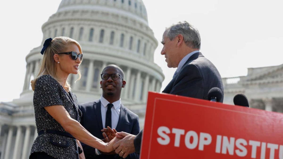 Actress and model Paris Hilton shakes hands with Sen. Jeff Merkley at a press conference outside the U.S. Capitol Building on April 27, 2023 in Washington, D.C.