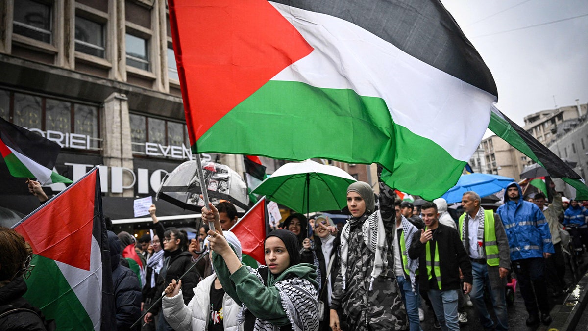 A participant waves a Palestinian flag