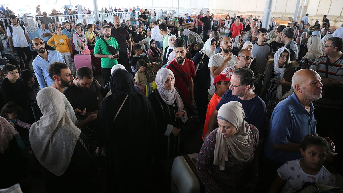 People wait to leave Gaza Strip for Israel