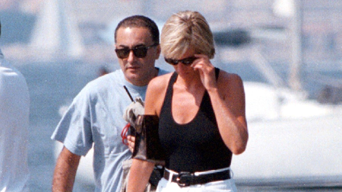 Princess Diana and Dodi Al Fayed walking together in Saint-Tropez trying to avoid the camera