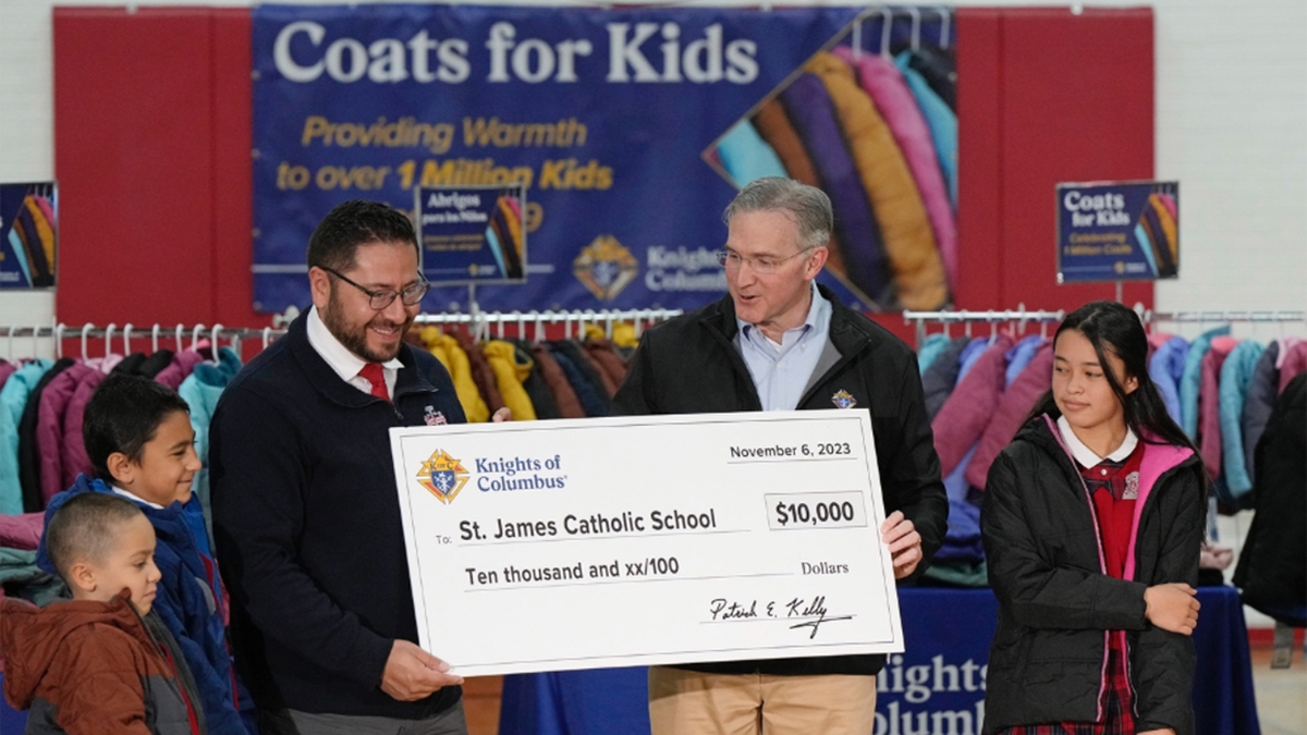 man holding large cheque