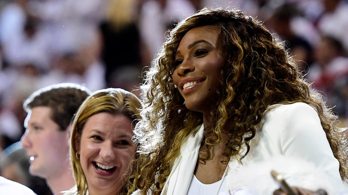 Serena Williams sits court side 