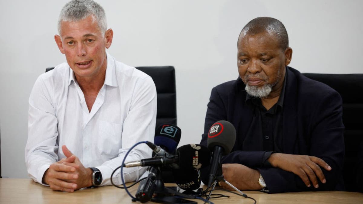 Impala Platinum CEO Nico Muller, left, and South African Minister of Mineral Resources and Energy Gwede Mantashe, right, speak during a press conference near Rustenburg 