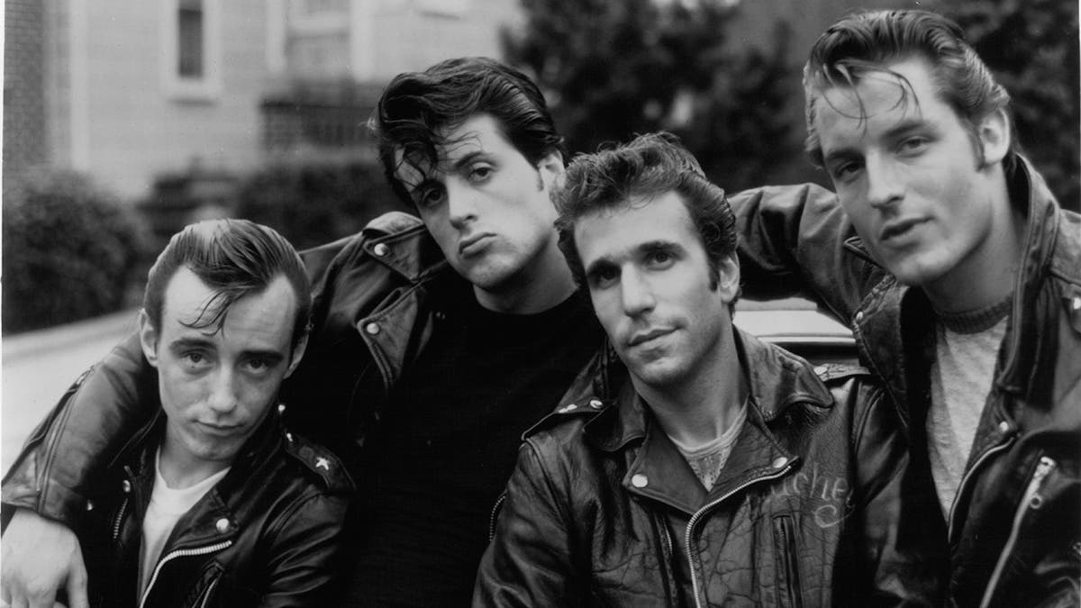 Paul Mace, Sylvester Stallone, Henry Winkler, and Perry King pose for picture in a scene from the film 'The Lords Of Flatbush', 