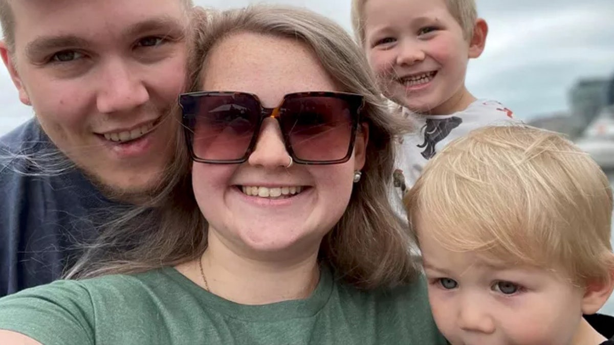 Family smiling in a selfie.