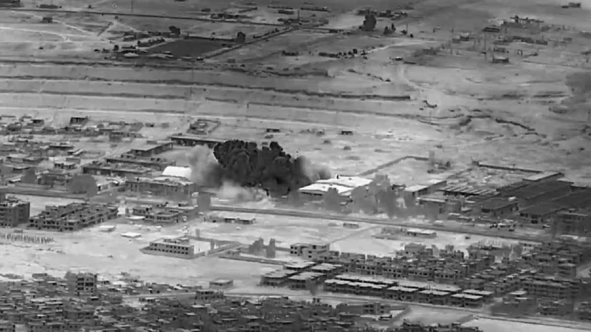 Black and white image of an airstrike in Syria