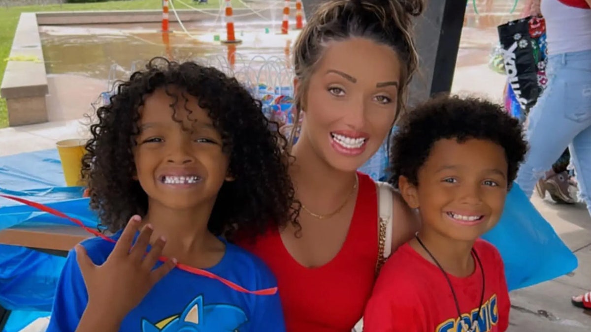 Mom poses with her sons.