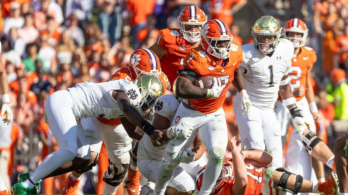 Clemson Tigers runs with the football