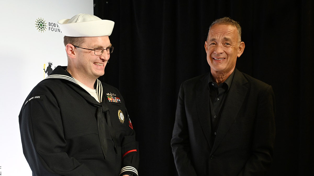 Tom Hanks posing with a member of the Navy