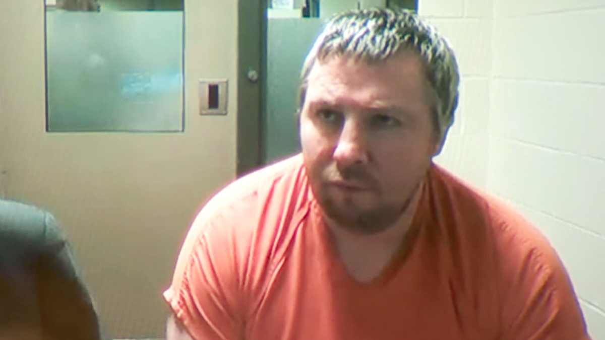 Timothy Burke in a jail jumpsuit