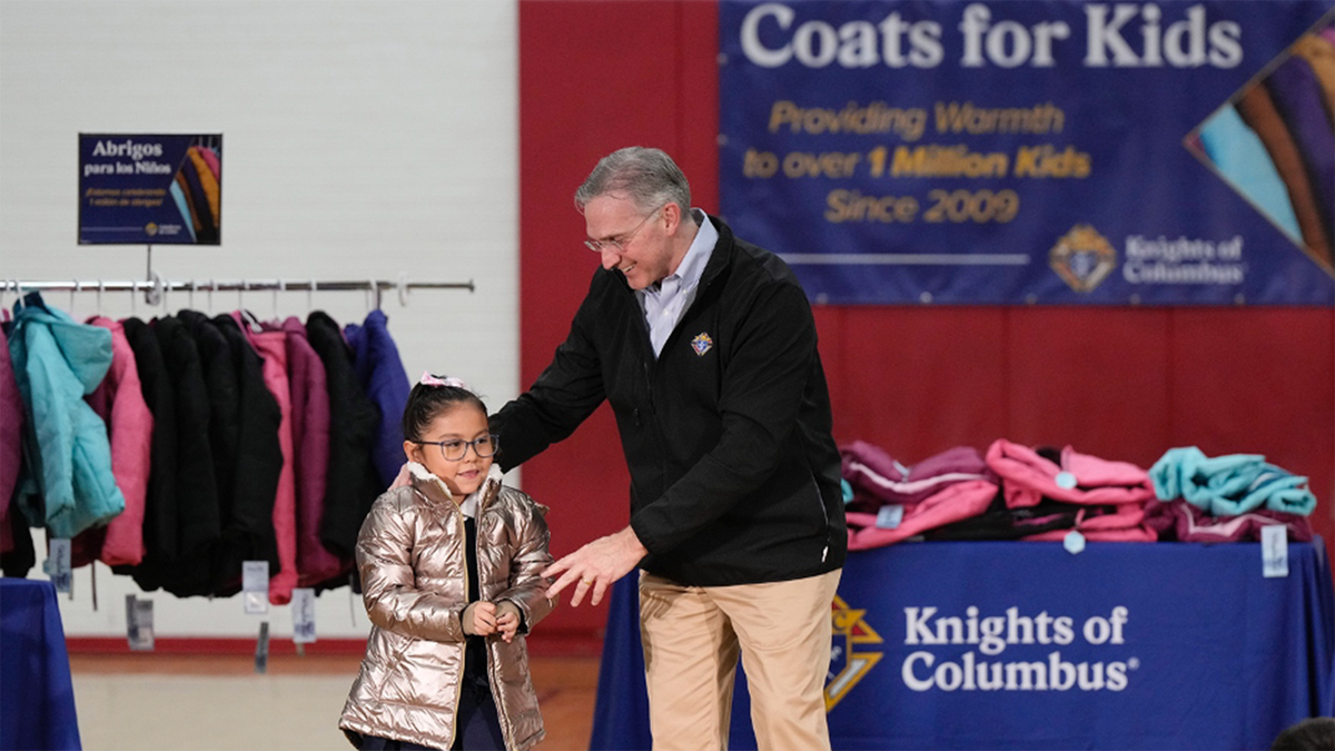 little girl in coat with Patrick Kelly