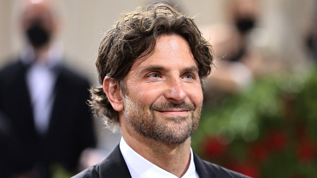 Bradley Cooper smiles on red carpet at Met Gala