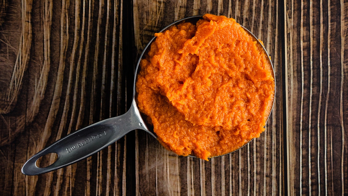 Measuring Cup Full of Canned Pumpkin Puree