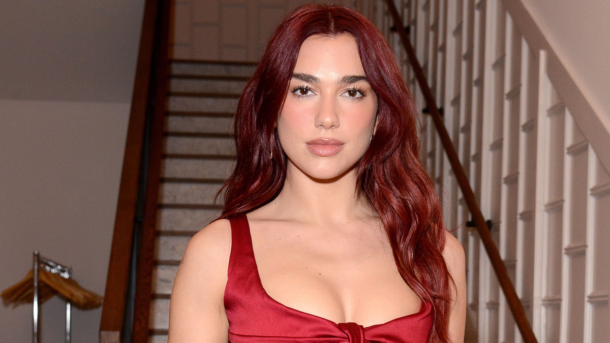 Dua Lipa in front of the staircase
