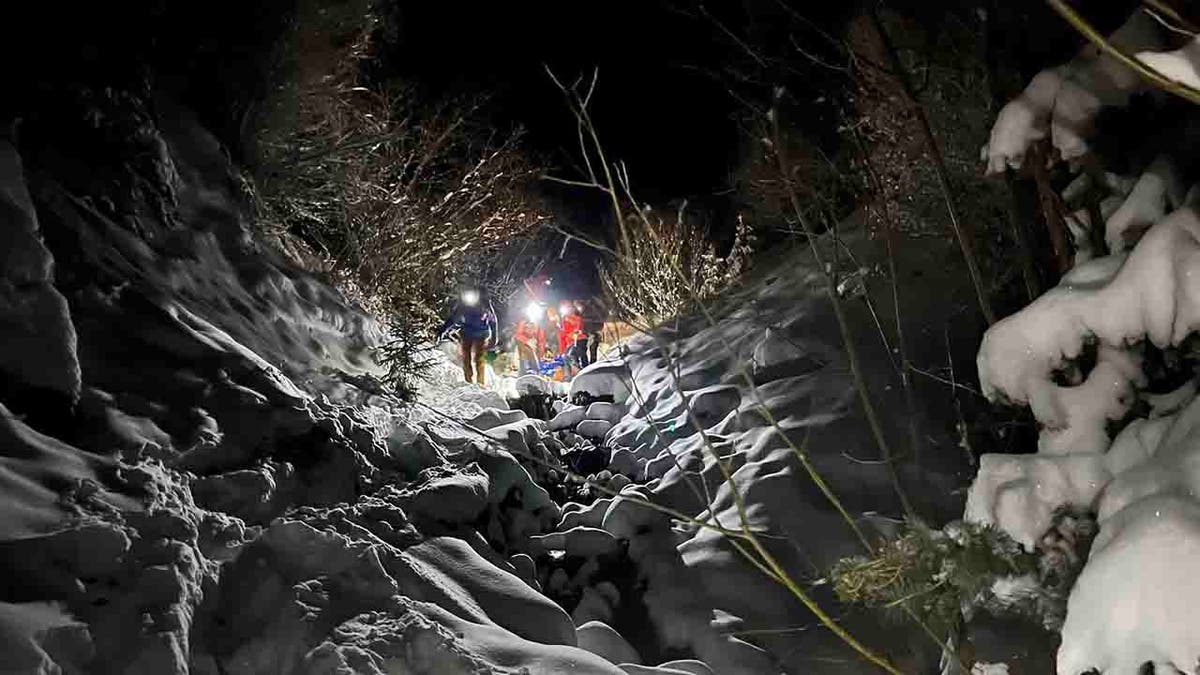 rescuers searching avalanche chute