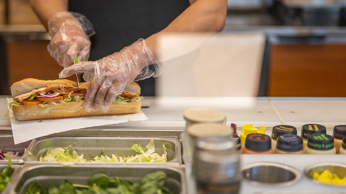 cutting a subway sandwich