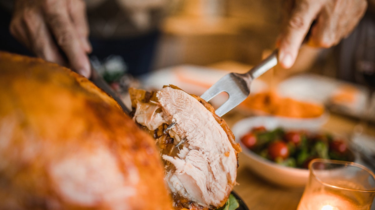 cutting the turkey on a platter