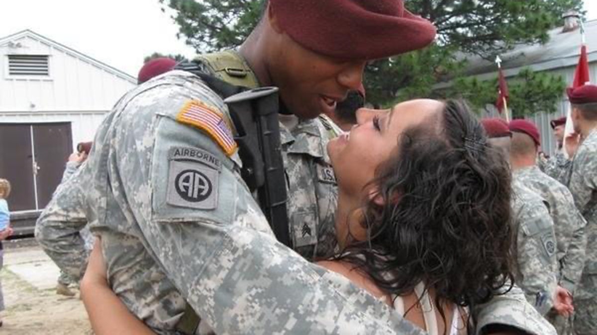 Army staff sergeant embraces his wife