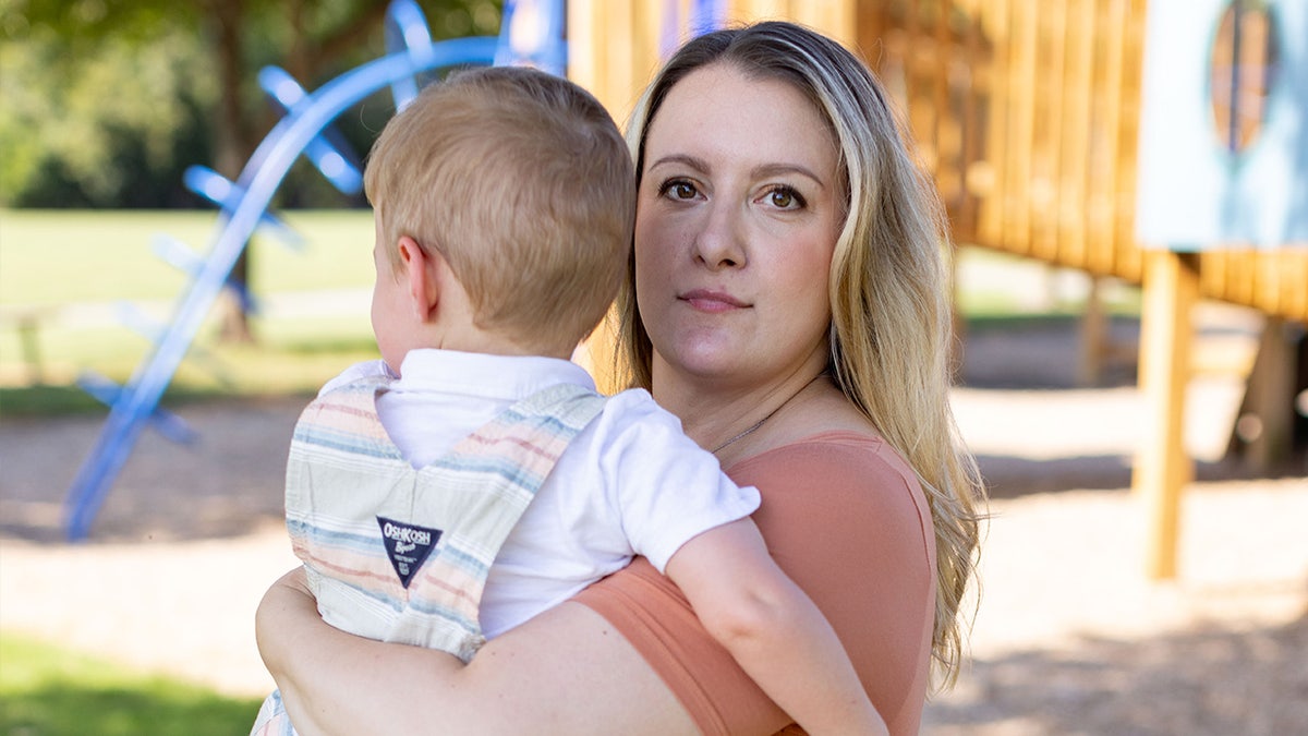 Erica Jedynak holds her son at a playground