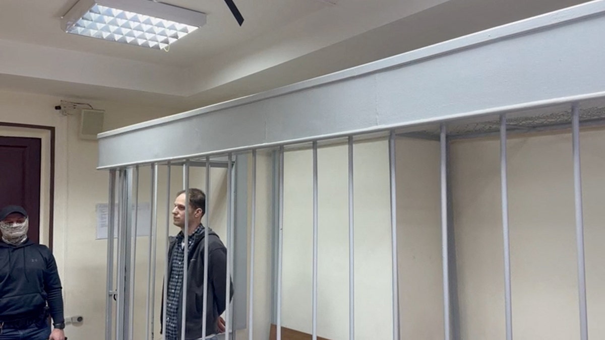 Evan Gershkovich stands in a Russian jail cell