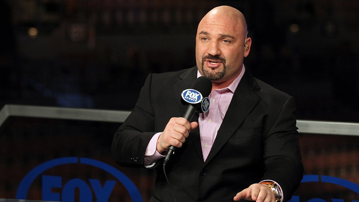 Jay Glazer holding microphone