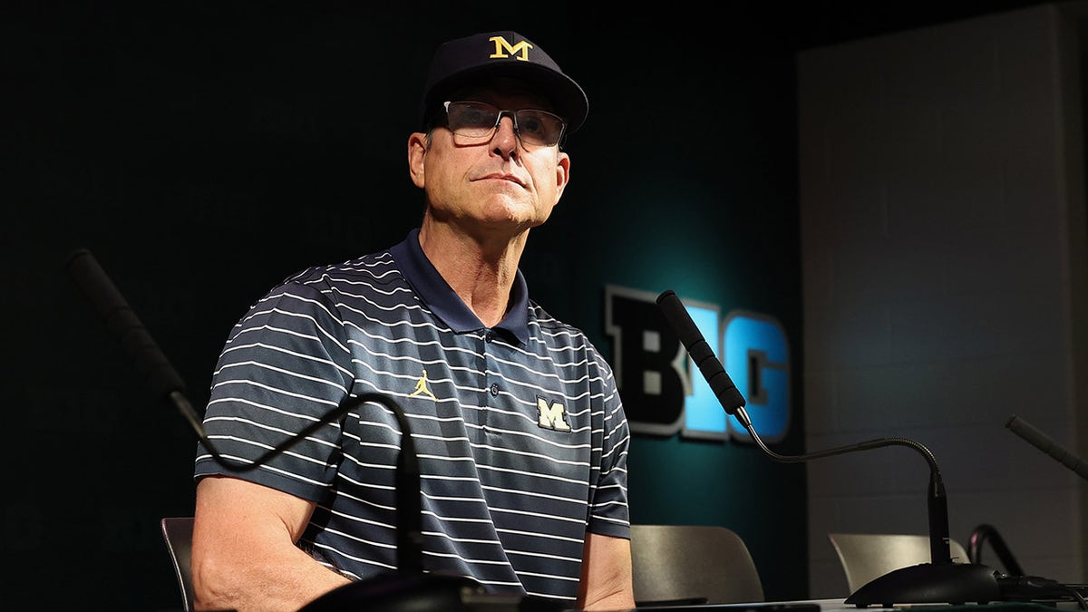 Jim Harbaugh speaks at a press conference