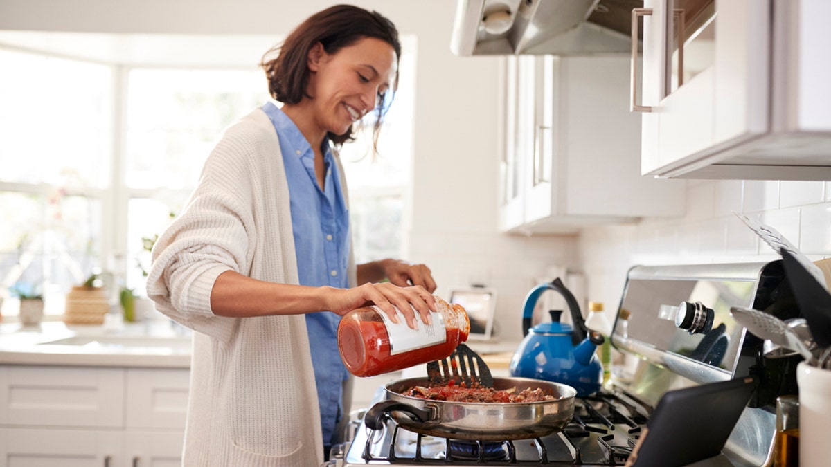 woman cooking on stove