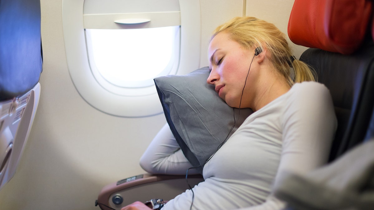 woman sleeping on plane