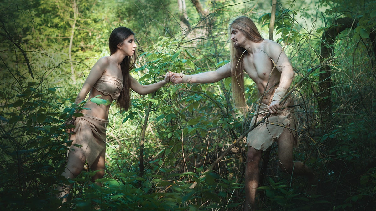 Prehistoric woman and man hunting