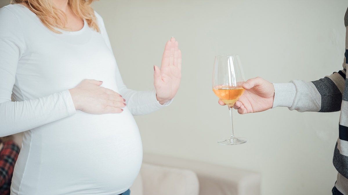 pregnant woman not accepting glass of wine