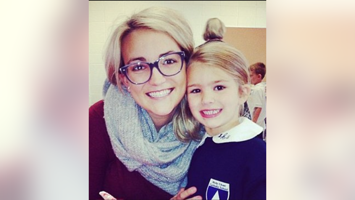 Jamie Lynn with black glasses smiling with daughter Maddie