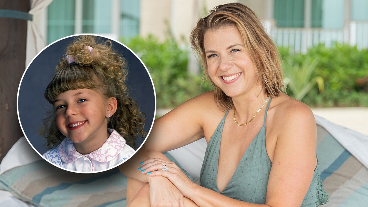 Jodie Sweetin in a green dress poses for a picture on a beach cabana inset a photo of young Jodie Sweetin as 'Stephanie Tanner' on "Full House"