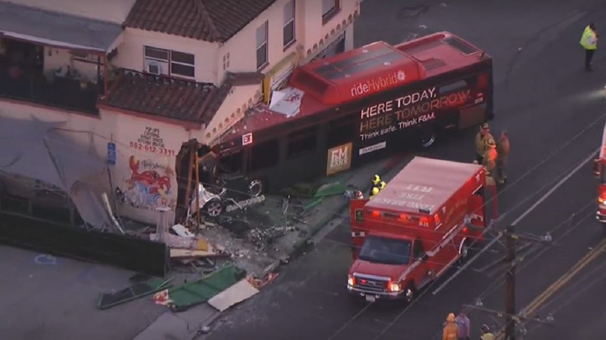 A bus seen partially inside a seafood restaurant after a crash