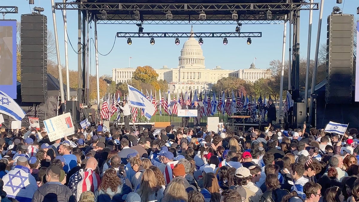March for Israel rallygoers stand in front of stage on National Mall