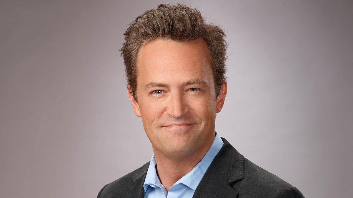Matthew Perry wears blazer and blue shirt for promos