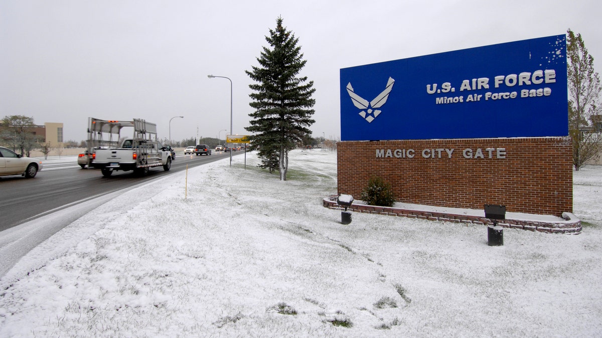 Minot AFB entrance sign, snow on ground on overcast day