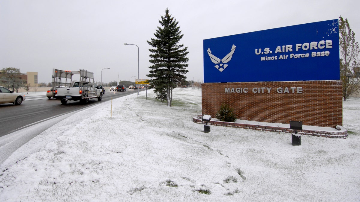 Minot AFB entrance sign, snow on ground on overcast day