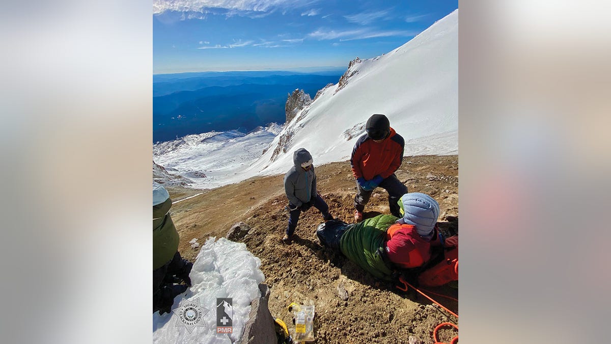 rescuers with injured hiker on mountain