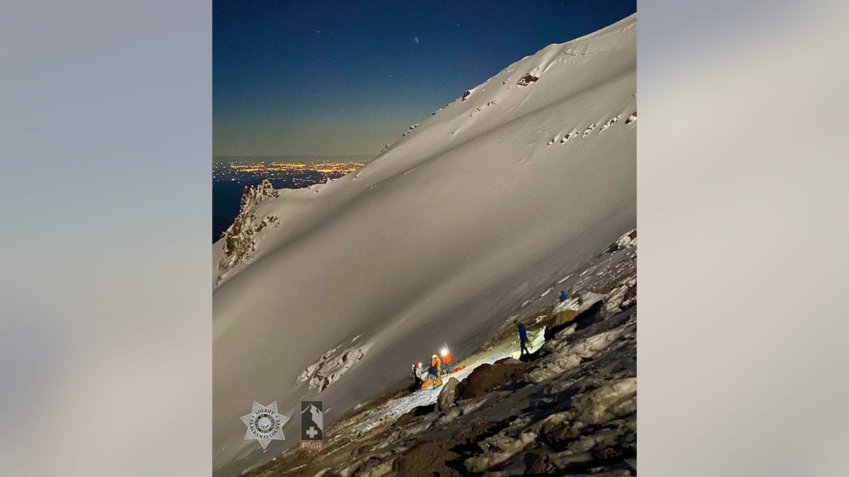 rescuers with injured hiker on mountain