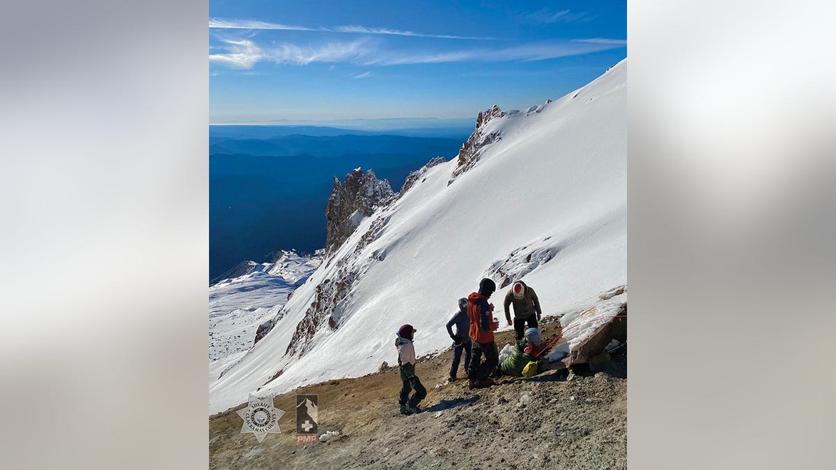 rescuers with injured hiker on mountain