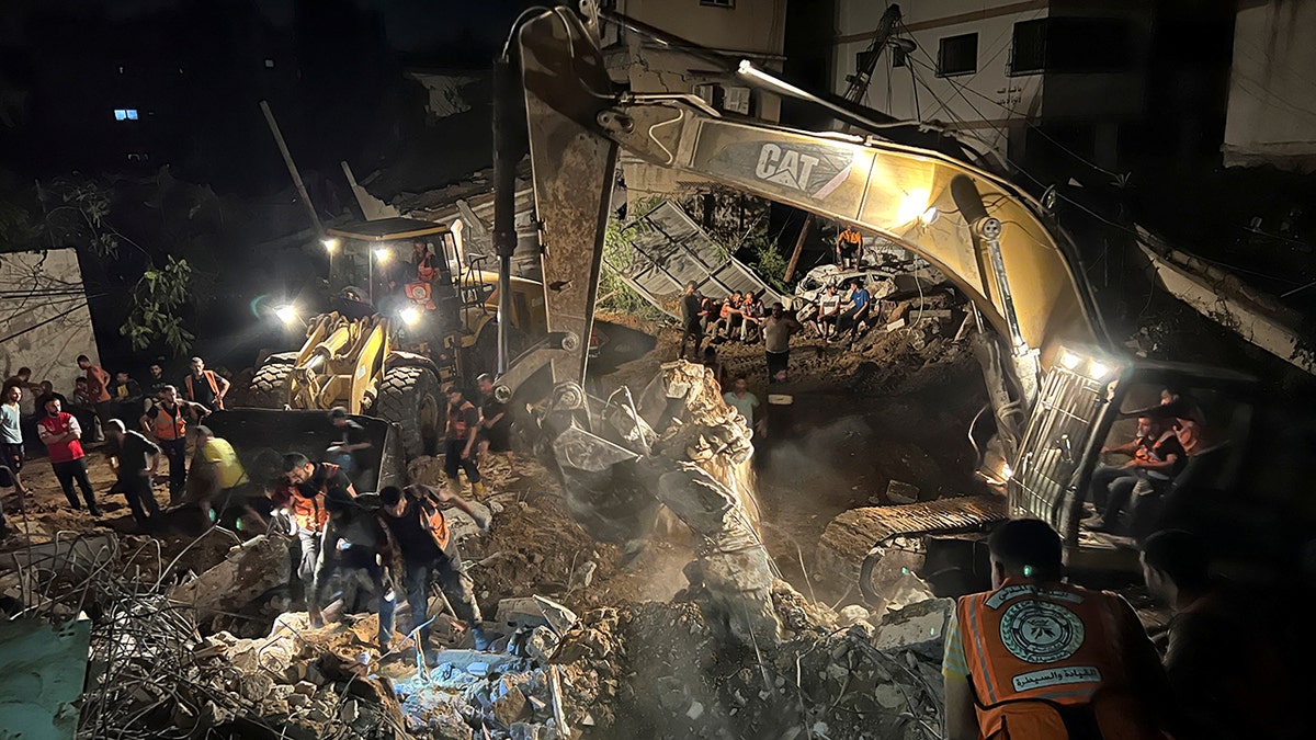 Palestinian rescue teams search rubble of house for survivors