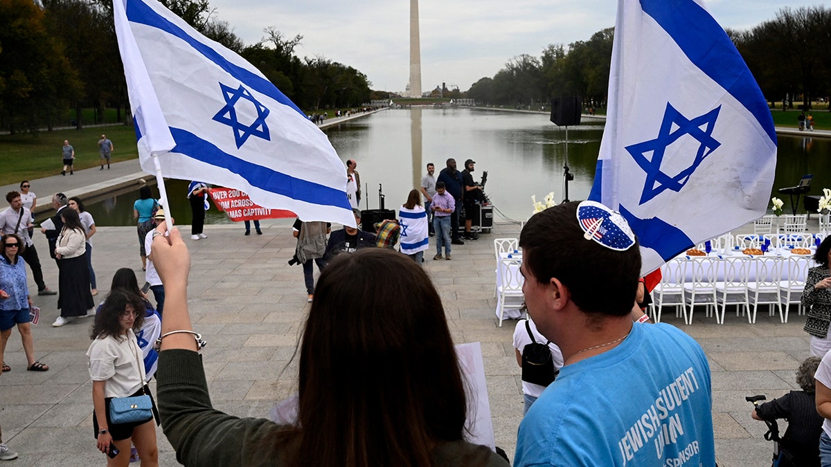 People wave flags of Israel at National Mall in Washington, D.C.