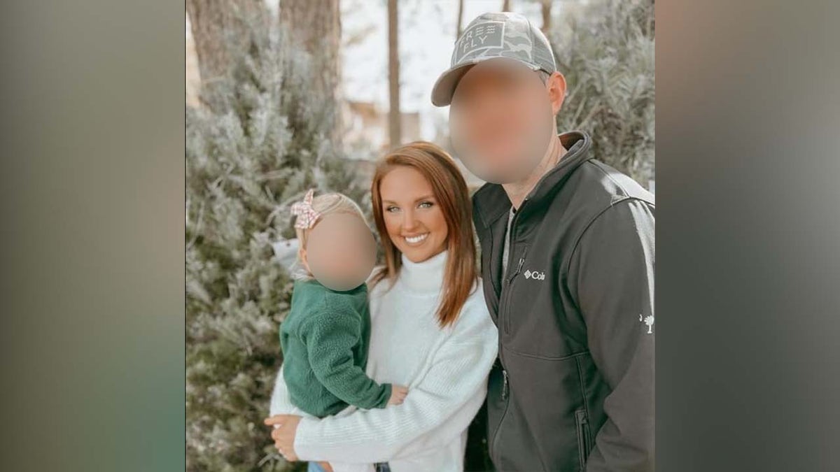 Photo of husband and wife with child.