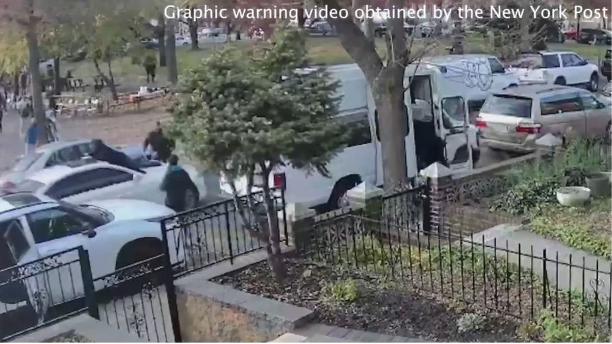 a screenshot of the victim on the hood of the car