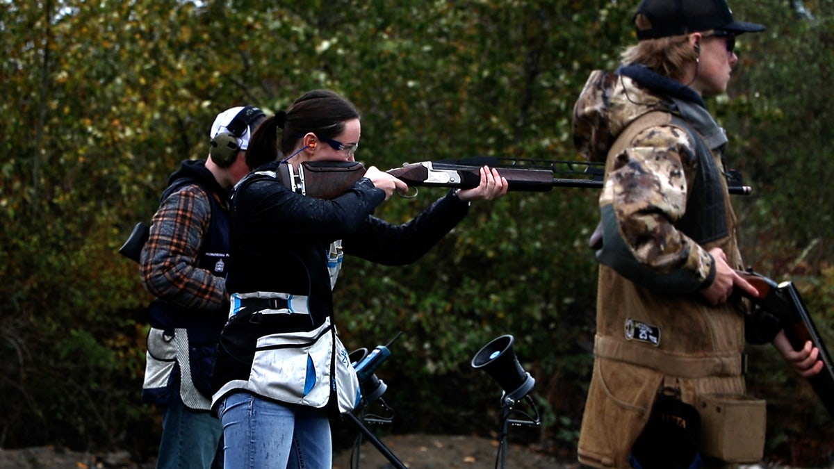 Girl aims shotgun at shooting range