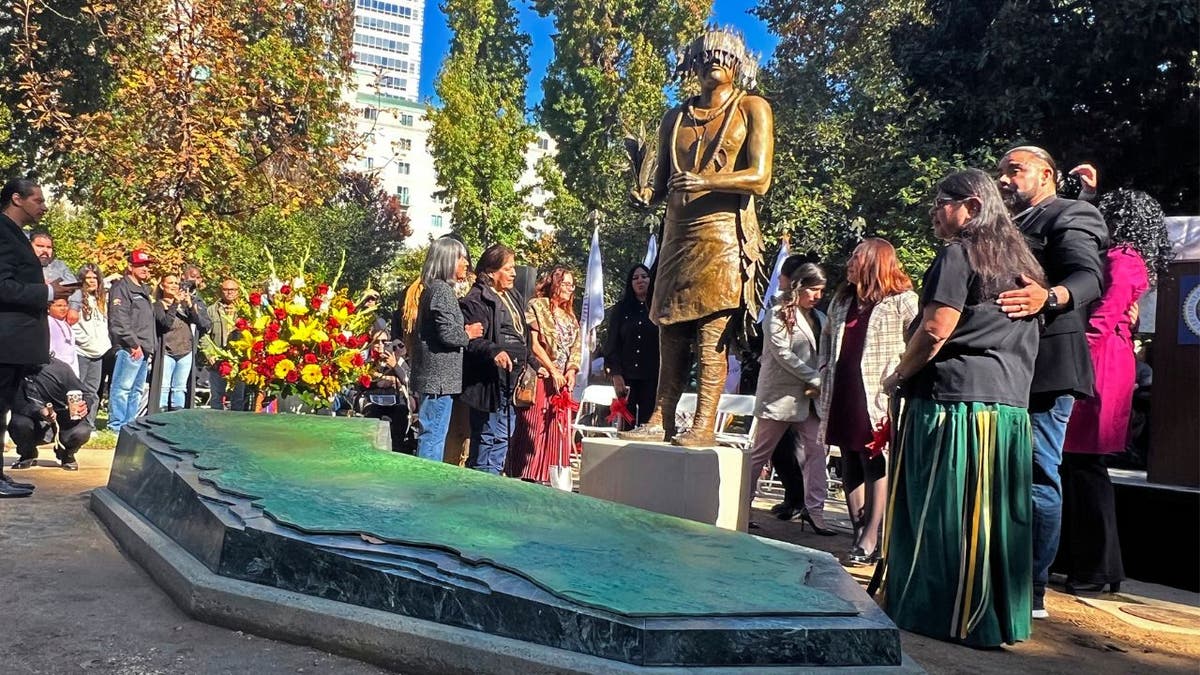 People gather around a statue of Miwok leader William J. Franklin Sr.