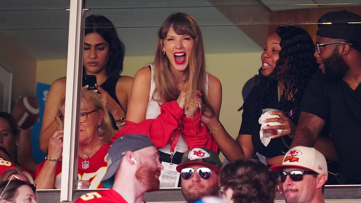 Taylor Swift laughs in a suite at Arrowhead Staidum