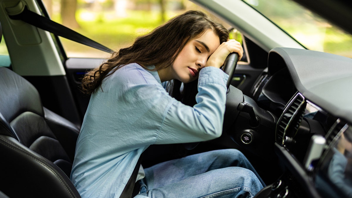 Teen tired at steering wheel