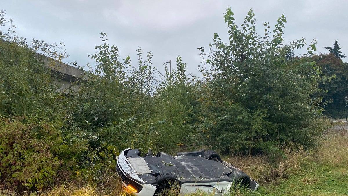 Ting ye's car upside down in a ditch after the crash