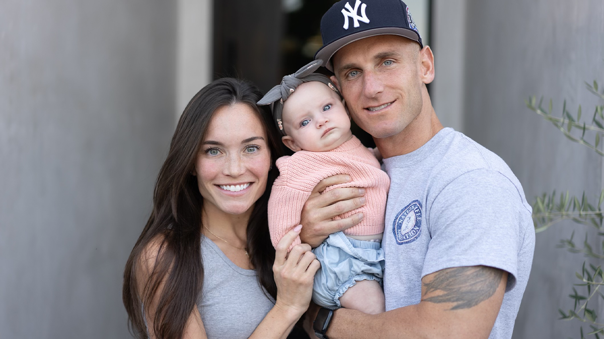 Vince Ricci with wife, left, and child
